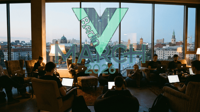 People sitting in a barely lit room with laptops, in front of a large window showing the Berlin skyline with the Vuejs Berlin logo.